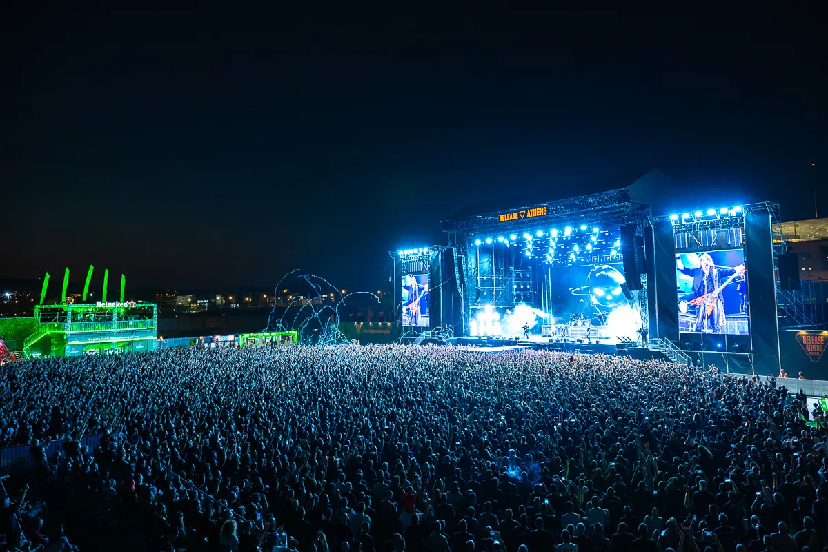 Festival-Hauptbühne mit großen Screens vor riesigem Publikum bei Nacht